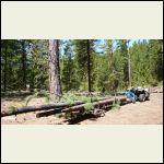 ATV towing a log arch (blue) and the back end supported by a home-made dolly