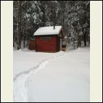 Looking up at the cabin, the snow, and my trail