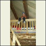 Looking up to the loft from the front of the cabin by the wood stove.