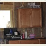 Stove at cabin with granite counter in