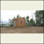 small cabin and outhouse