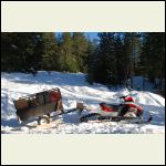 Garden trailer with Snowboard runners.  Recommended to add narrow 'keels' to the bottom of the board