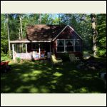 cabin in shadow of trees