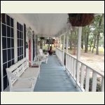 View down porch with seating being left