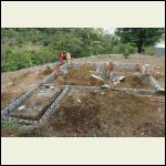 Foundation's in. Pouring concrete for wooden column supports.