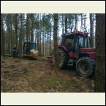 Tractor moving logs