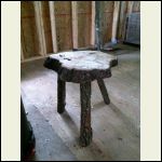 A stool to sit on while putting wood in the stove