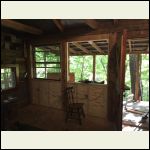 Back wall of the cabin over looking creek.  Solid wall here previously. Mid process...