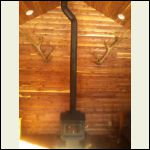 end wall with elk antlers and wood stove end wall with elk antlers and wood stove