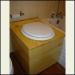 Composting toilet, made of 1 by lumber and  polyurethaned.