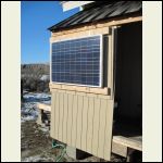 Solar panel mounted on South-facing exterior wall.