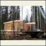 roof being put on the cabin walls