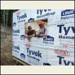 Adding Tyvek to the house; not easy given that it seemed to rain every day during out first summer!